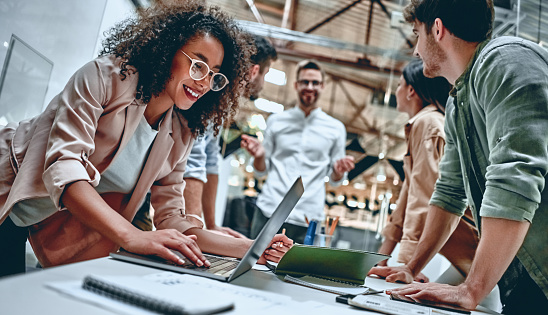 Group of young multiracial business people are working in modern office. Freelancers in coworking place. Creative and stylish youth.