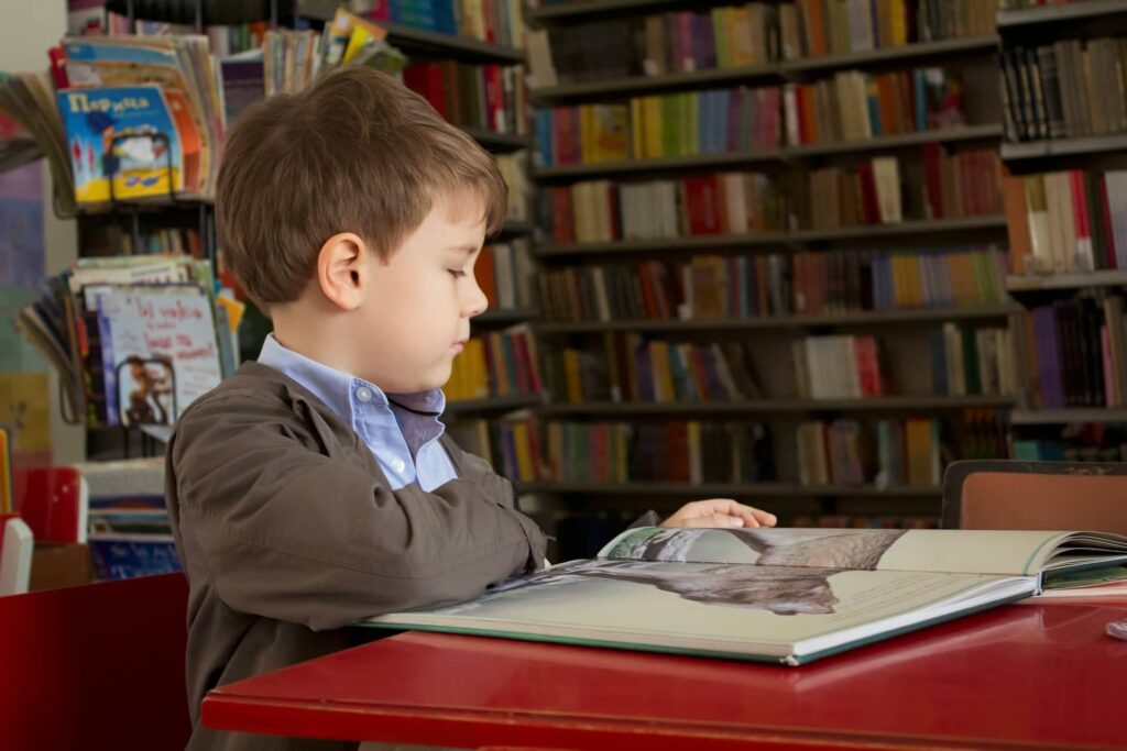 school boy reading book
